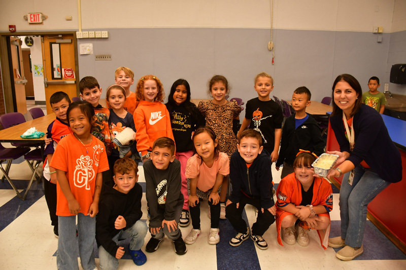 students in classroom pose for a group  shoot