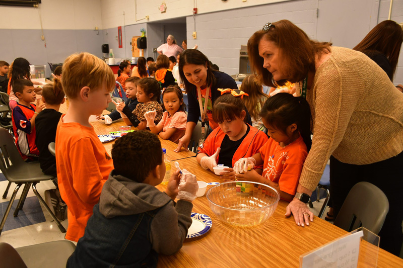 students in classroom at table with food