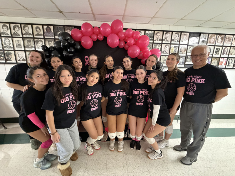 students in group photo all dressed in the same black t shirts