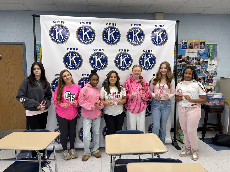 students in front ot Kiwanis banner