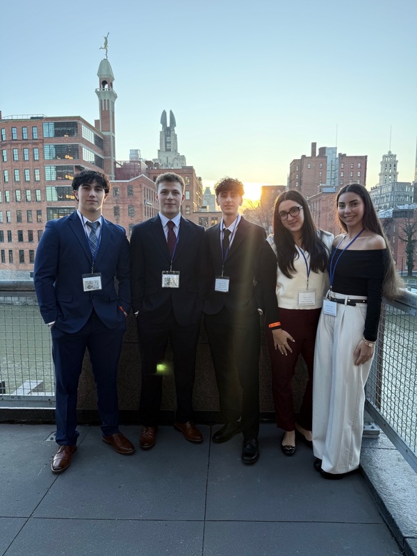 Students standing on balcony.
