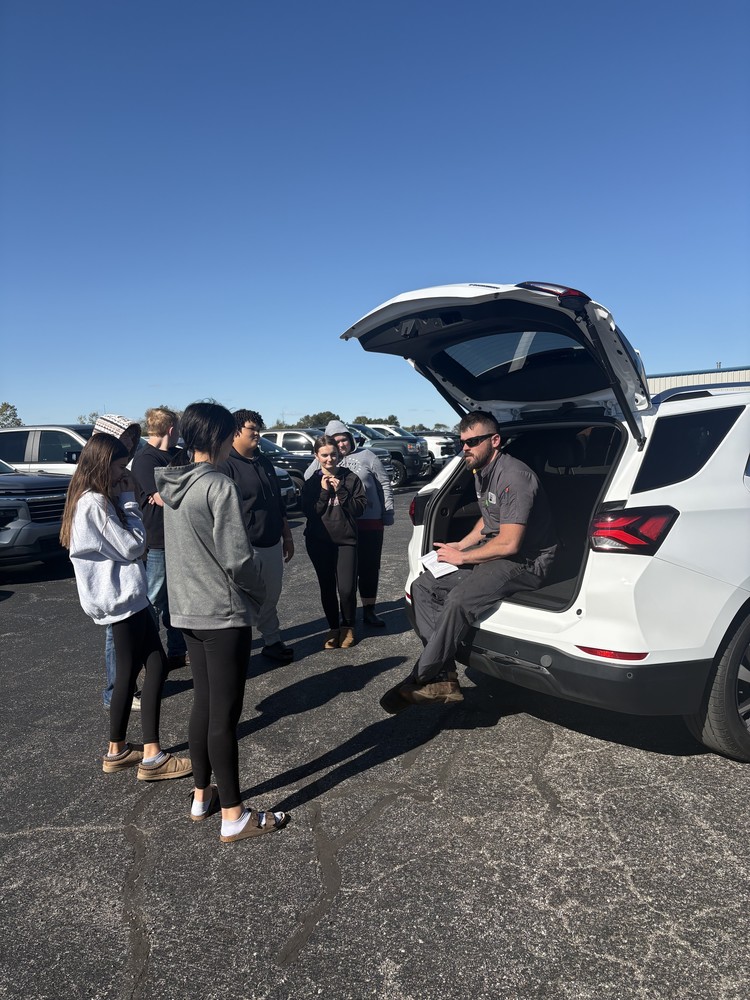 K & J mechanic T.C. Johnson discusses vehicle maintenance with a group of Carlyle High School students during their CTE Careers class.
