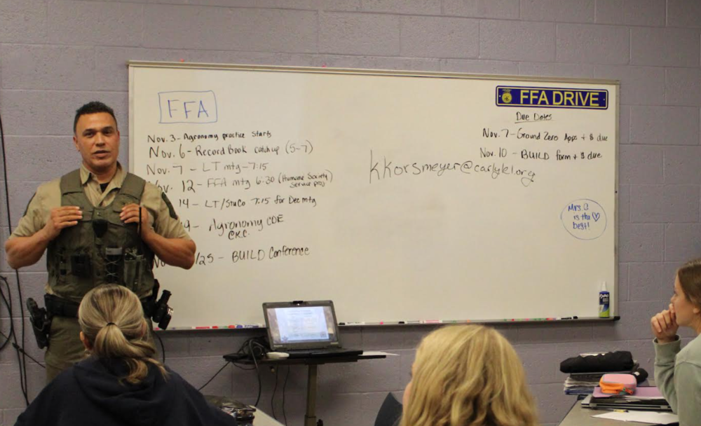 Macias is seen speaking to students