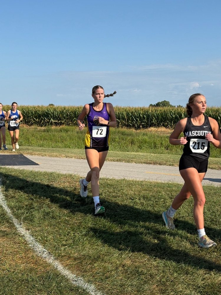 two female runners are seen running through a grassy area