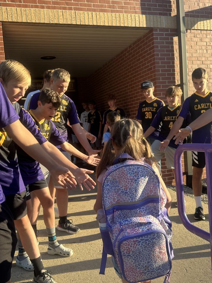Students are seen being greeted by the CHS Soccer team as they walk into school.