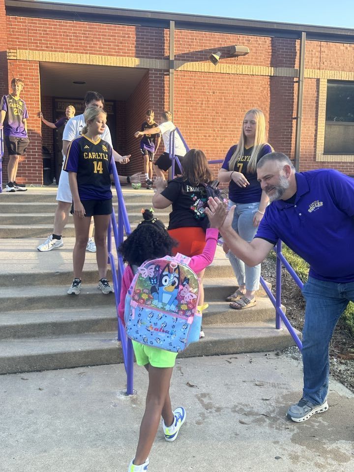 Students are seen being greeted by the CHS Soccer team as they walk into school.