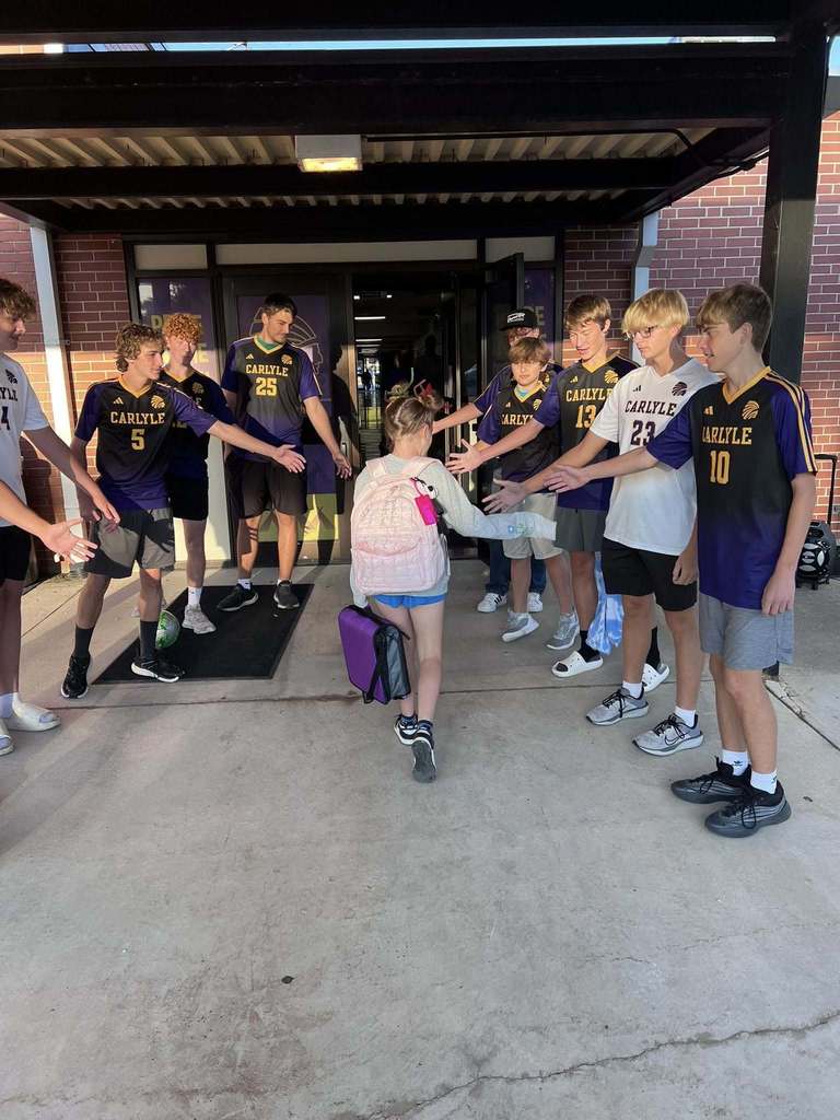 Students are seen being greeted by the CHS Soccer team as they walk into school.