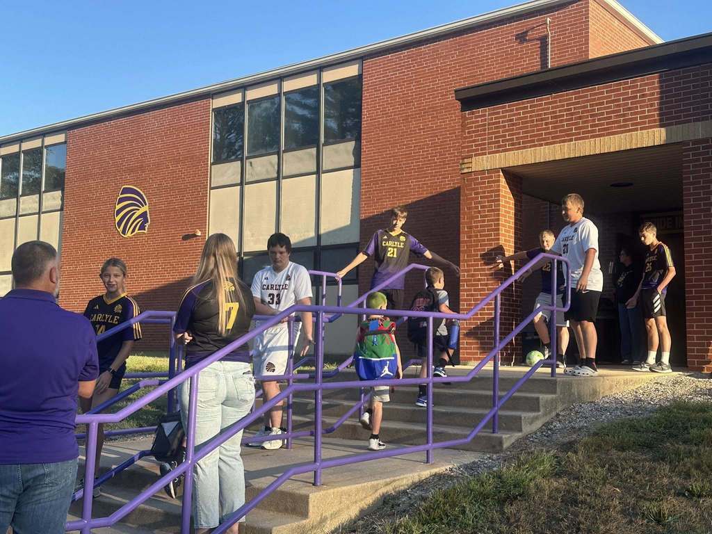 Students are seen being greeted by the CHS Soccer team as they walk into school.