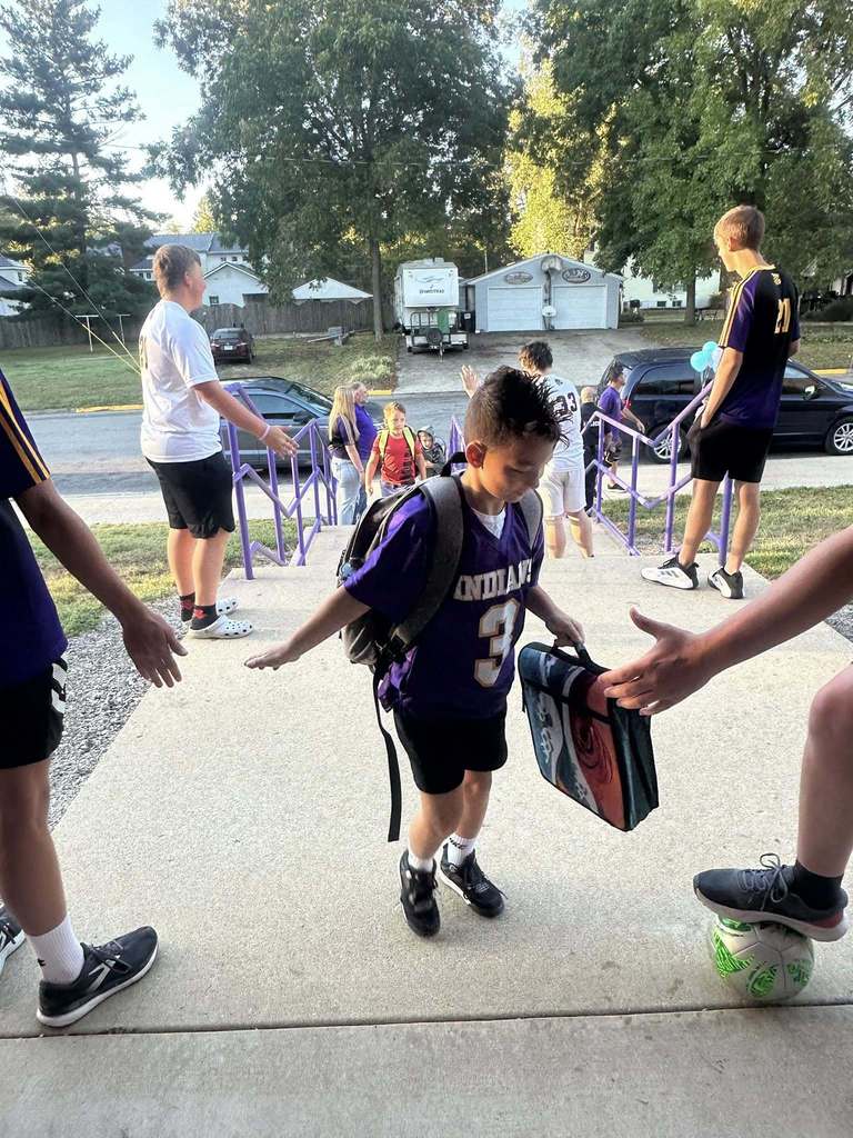 Students are seen being greeted by the CHS Soccer team as they walk into school.