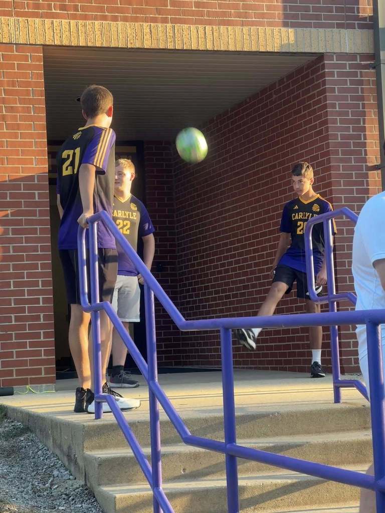 Students are seen being greeted by the CHS Soccer team as they walk into school.