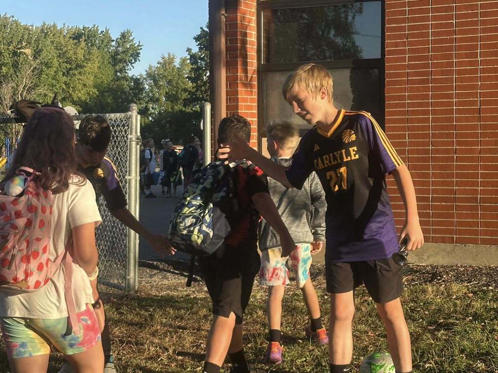 Students are seen being greeted by the CHS Soccer team as they walk into school.