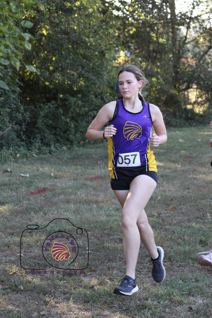 Peyton runs through a wooded area.