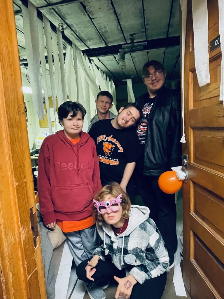 Life skills students pose for a photo after pranking Coach Taylor.