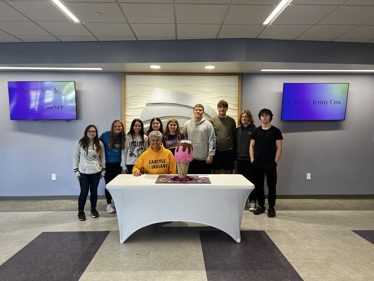 students pose with the candyland pumpkin