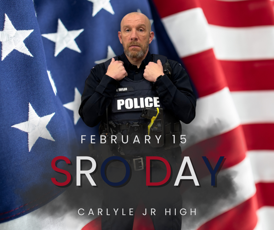 Graphic celebrating School Resource Officer Day featuring a portrait of Officer Taylor from Carlyle High School in uniform on the right, looking forward. An American flag is displayed prominently on the left. The background is dark with a subtle smoky effect, and the text reads, “Happy SRO Day Officer Taylor! From Carlyle High School.”