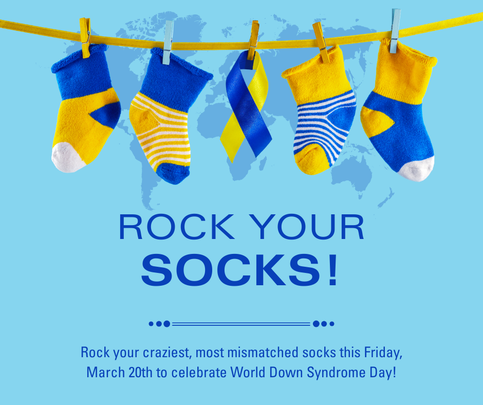 A horizontal blue poster features five mismatched yellow and blue socks on a clothesline, each with a wooden or light-blue clothespin, against a faded world map background. A twisted blue and yellow ribbon hangs in the center. Bold dark blue text below reads, "ROCK YOUR SOCKS!" Further down, smaller dark blue text says, "Rock your craziest, most mismatched socks this Friday, March 20th to celebrate World Down Syndrome Day!" with three small dots on either side of the date.