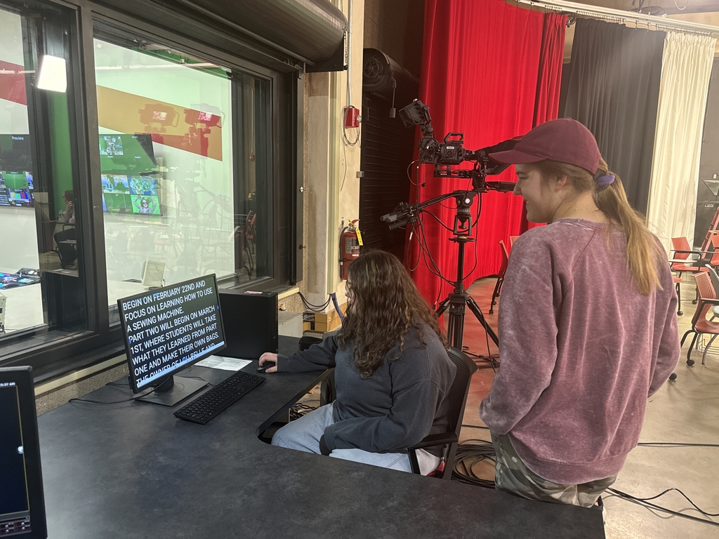 Senior Mary Ann Brown controls the teleprompter's pace for her peers on camera. Junior Maggie Bass watched and waited for her turn at the controls.