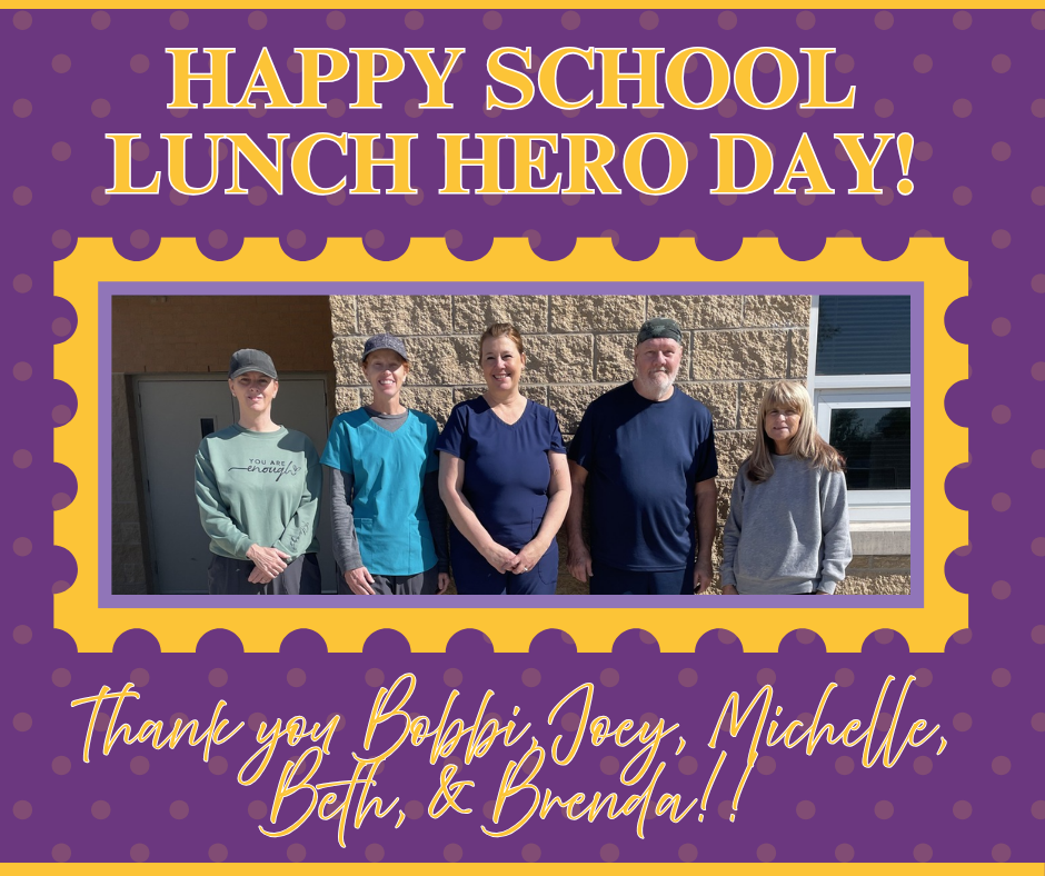 A purple poster with polka dots celebrating “National Cafeteria Worker Day.” In the center is a framed photo of five cafeteria staff members standing outside against a brick wall, smiling at the camera. Their names are written around the photo: Mrs. Bobbi, Mr. Joey, Mrs. Michelle, Mrs. Brenda, and Mrs. Beth.
