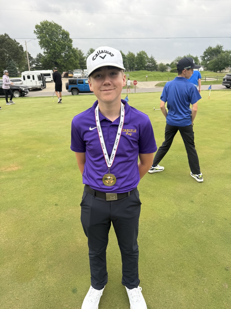photo of young golfer on the green with a medal