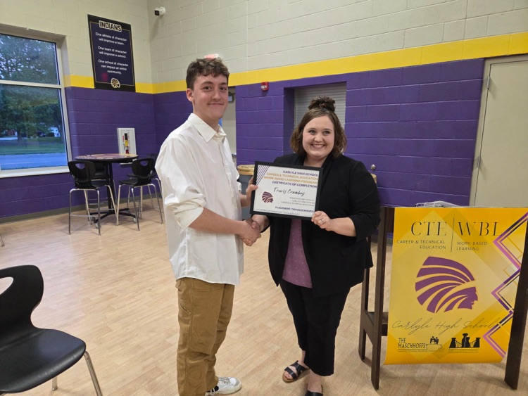 photo of Travis getting certificate from Mrs. I