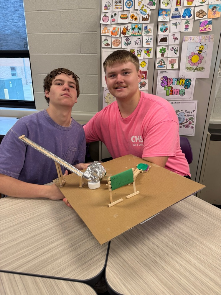 students pose with their coasters