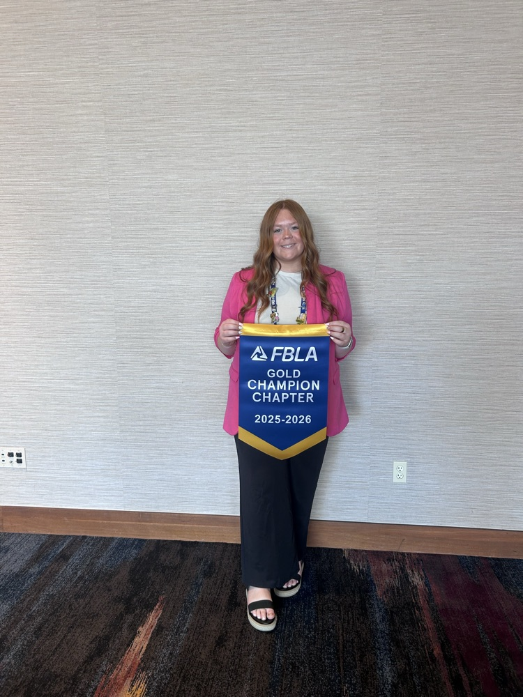 Mabry holding gold champion chapter banner