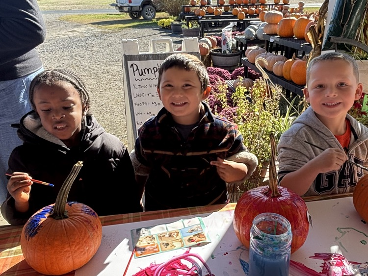 PK students painting pumpkins 