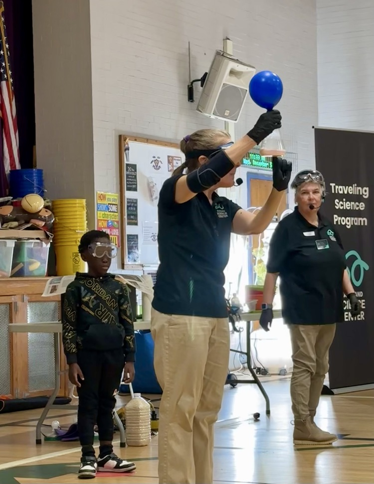student and presenters for science center assembly