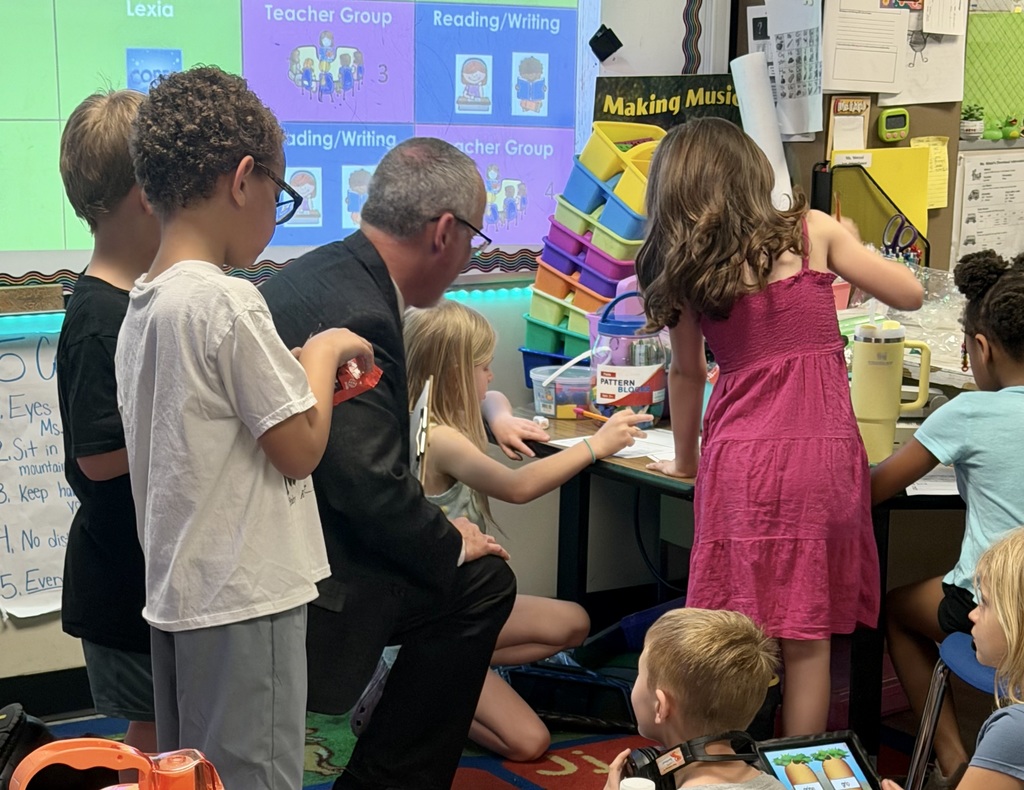 superintendent and students working together