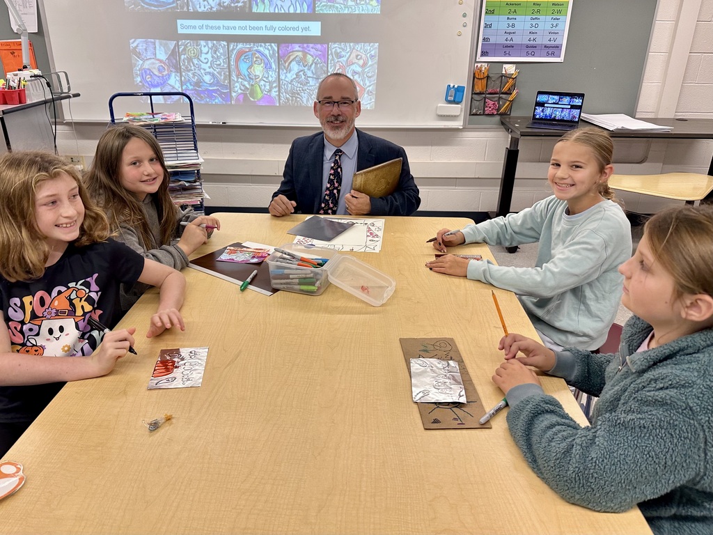 Dr. Simmons at table with students