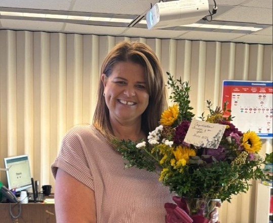 Picture of Teacher of the Year holding flowers