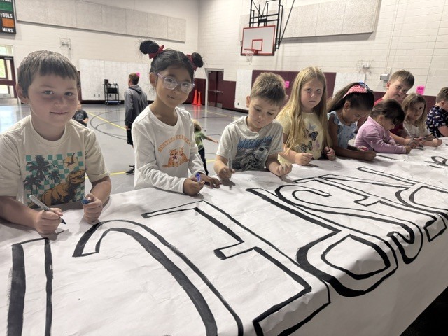 Students signing respect banner 