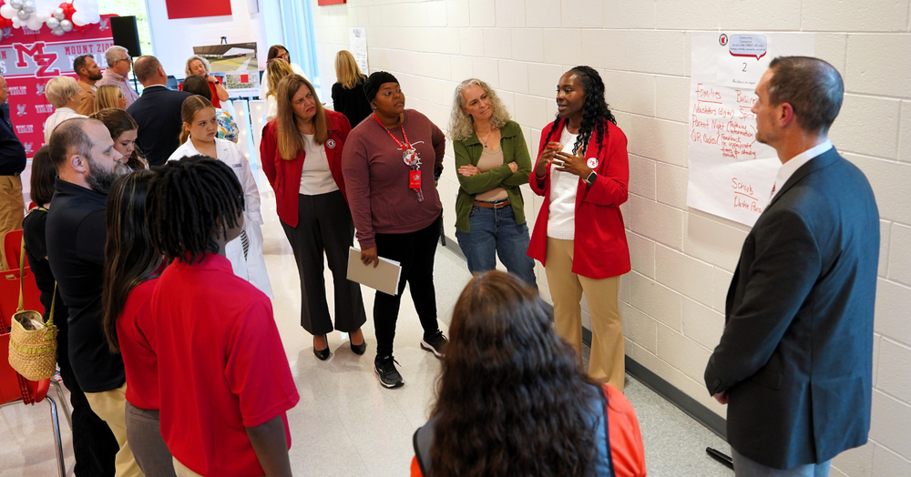 a group of parents and community partners are led in a feedback session with Mount Zion school administrators