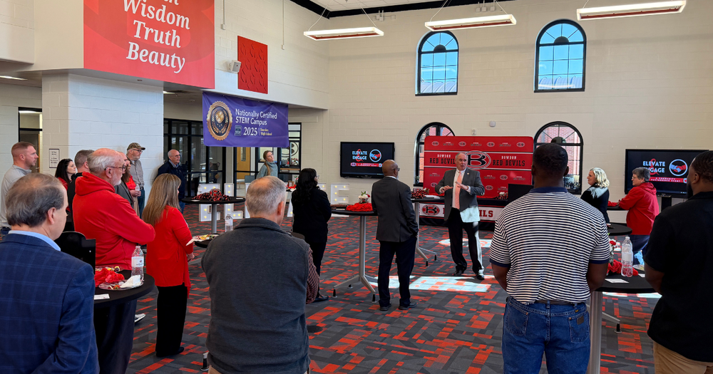a crowd of Bowdon community members listens as district and cluster leaders share updates