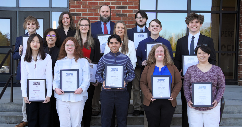 a group of students and teacher holding plaques. Front row: Bowdon High STAR Student Abigail Cihla, Bowdon High STAR Student Alyssa Pate, Villa Rica High STAR Student Kieran Lively, Temple High STAR Teacher Lydia Clarke, Temple High STAR Teacher Alison Parker. Second row: Bowdon High STAR Teacher Kristy McKinzey, Bowdon High STAR Teacher Emily Graffius, Villa Rica High STAR Teacher Janene Browning, Temple High STAR Student McKennan Pannell, Temple High STAR Student Jack Jones. Third Row: Central High STAR Student Maxwell Kubik, Central High STAR Teacher Jacklyn Ross, Mount Zion STAR Teacher Mark Richardson, Mount Zion STAR Student Zachary Purvis