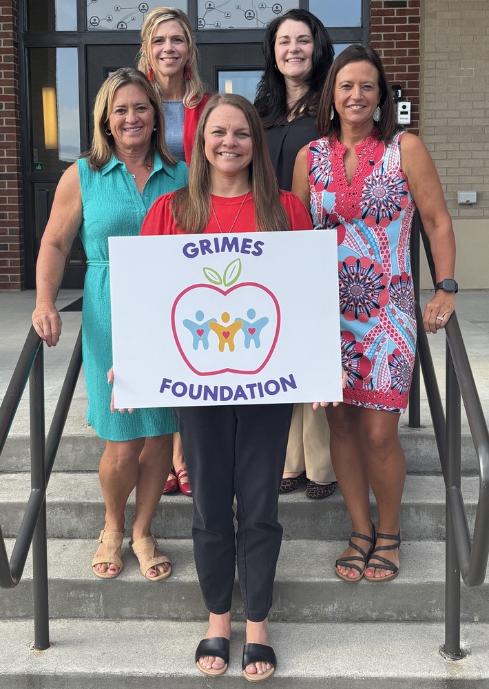 representatives from the Grimes Foundation pose with Carroll Co. School representatives outside the Performing Arts Center