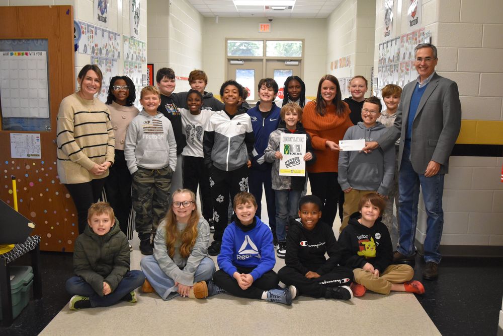 Bright ideas grant recipient and students pose for a photo with Carroll EMC representatives