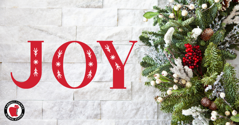 the word JOY next to the image of a holiday wreath