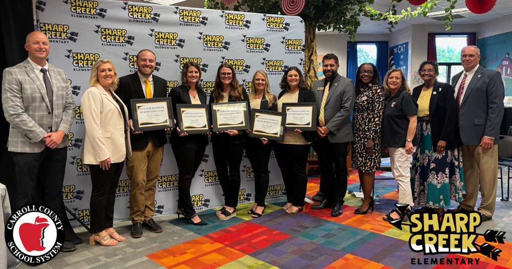 sharp creek elementary school leaders pose with system leaders and their plaque announcing national STEM certification