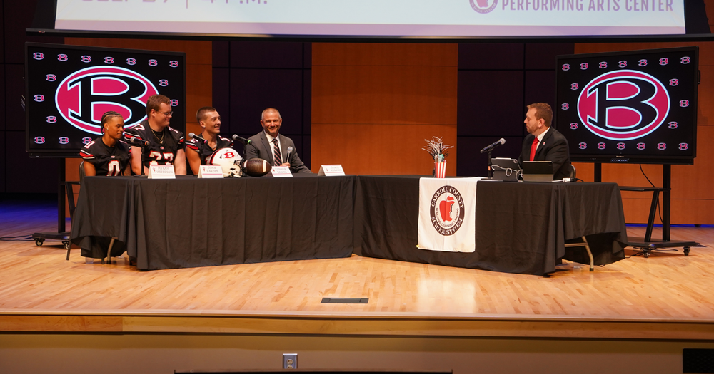 Bowdon head coach and players discuss the new season with Carroll County's Seth Cain on stage at the P A C