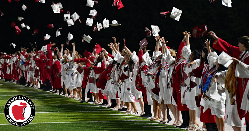 mzhs graduates toss their mortarboard caps in the air