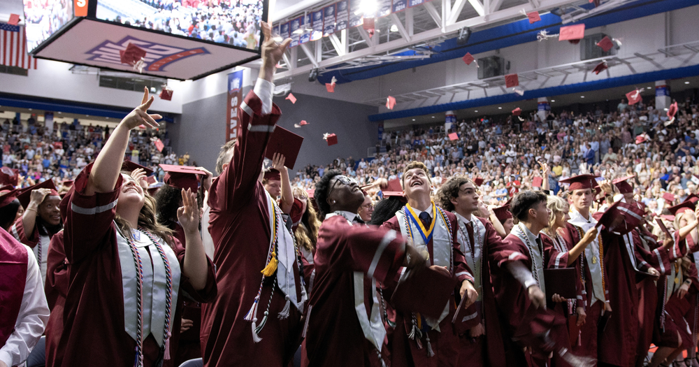 central high school graduates toss their caps in the air at commencement exercises