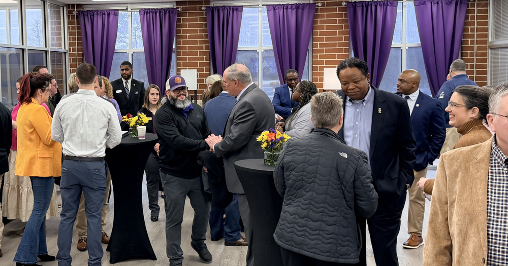 Superintendent Scott Cowart and other school and district administrators greet guests at a recent community partnership event at Villa Rica High School.