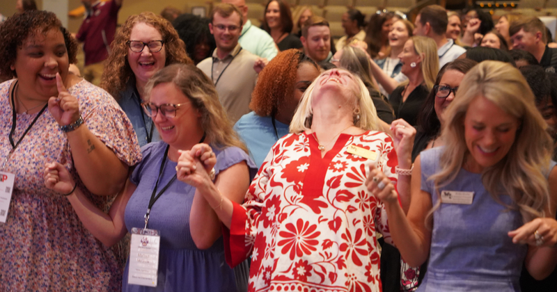 teachers and admins laugh together during a group activity
