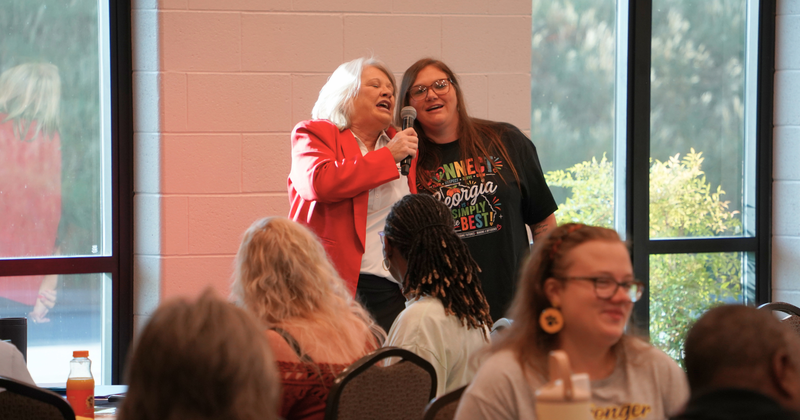 school nutrition workers sing during their rally