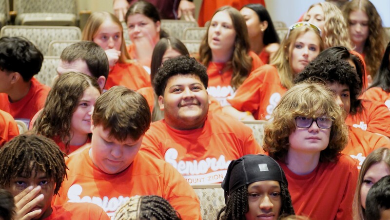 a crowd of high school seniors at the performing arts center