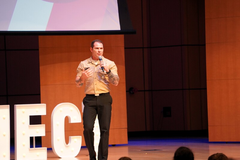 Petty Officer First Class Charles Gordon speaks on stage