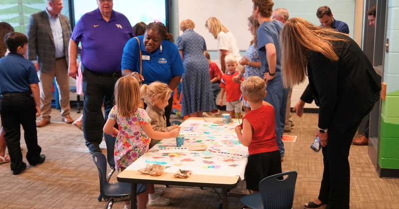 children at a painting station in a lab