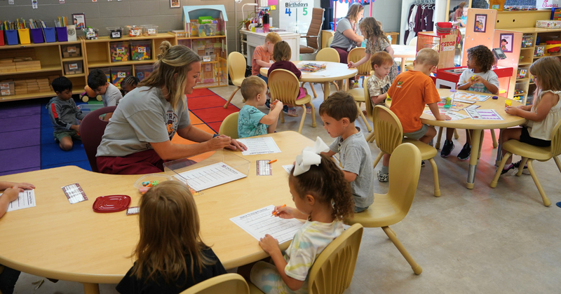 students learn at stations with teachers
