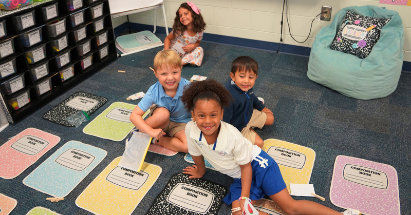 students pose while working together